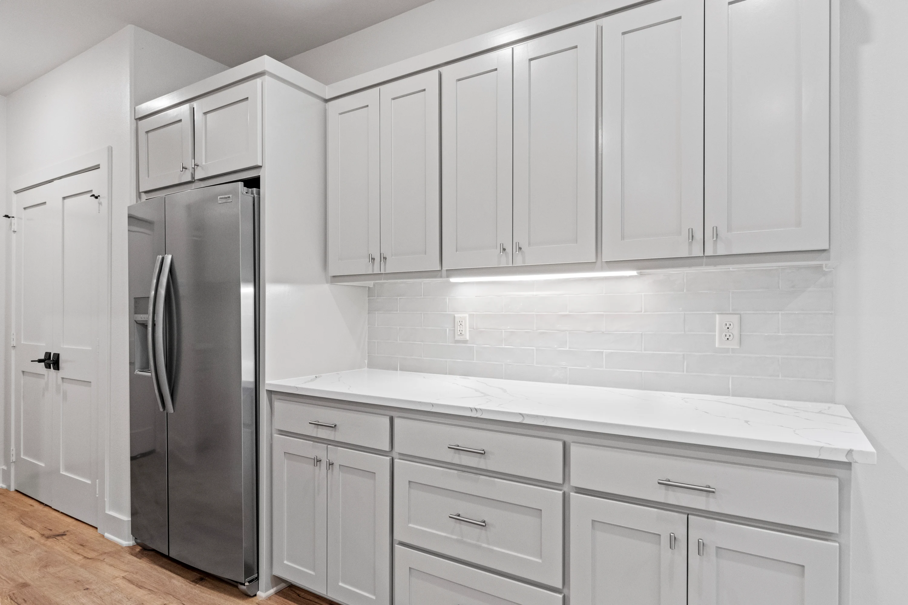 Primary bathroom with dual quartz-topped vanities in a 6854 Lazy Vale duplex residence.