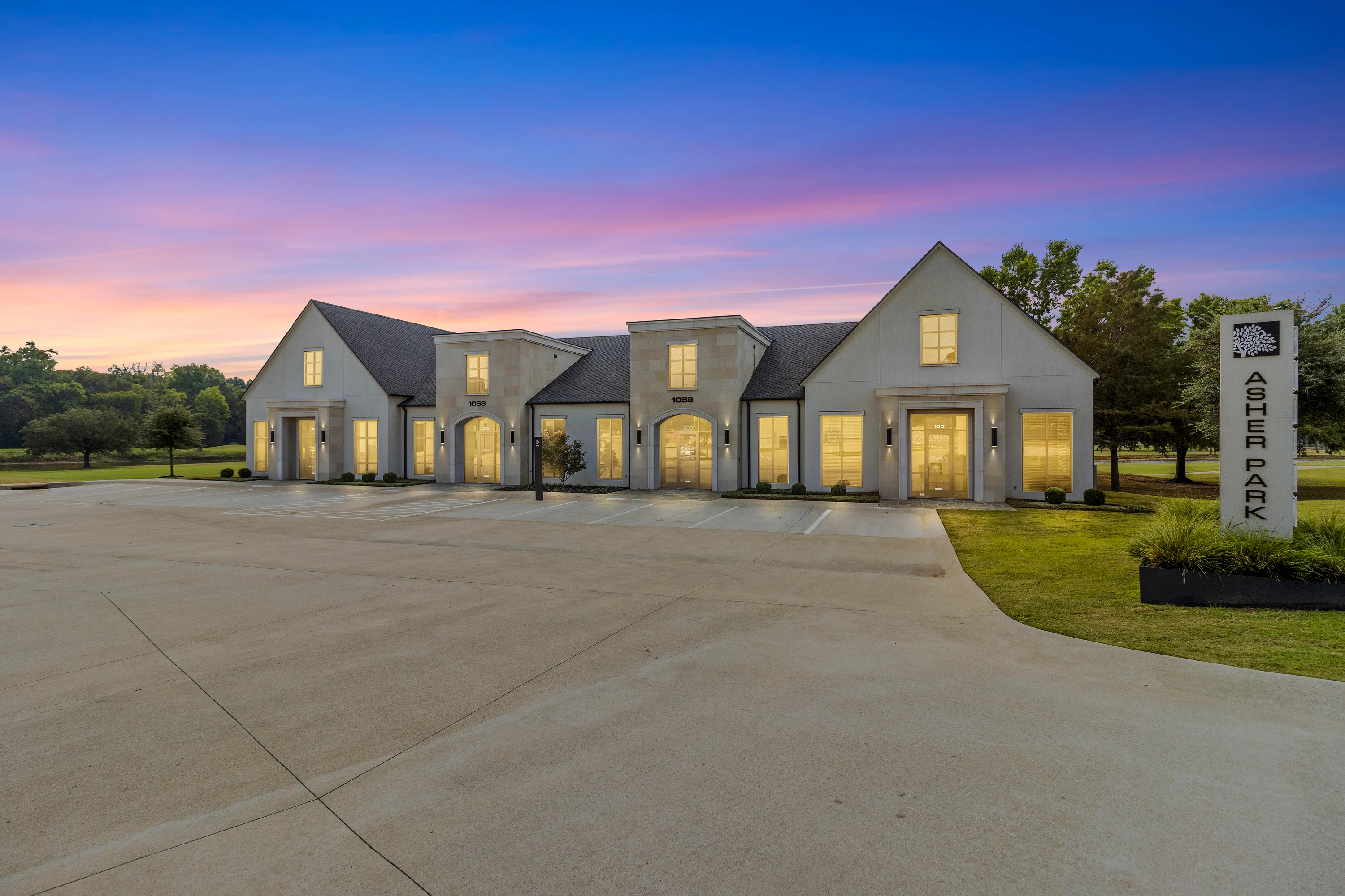 Alternate exterior view of the Asher Park garden office building with drive-up parking at 1028 Asher Way in Tyler.