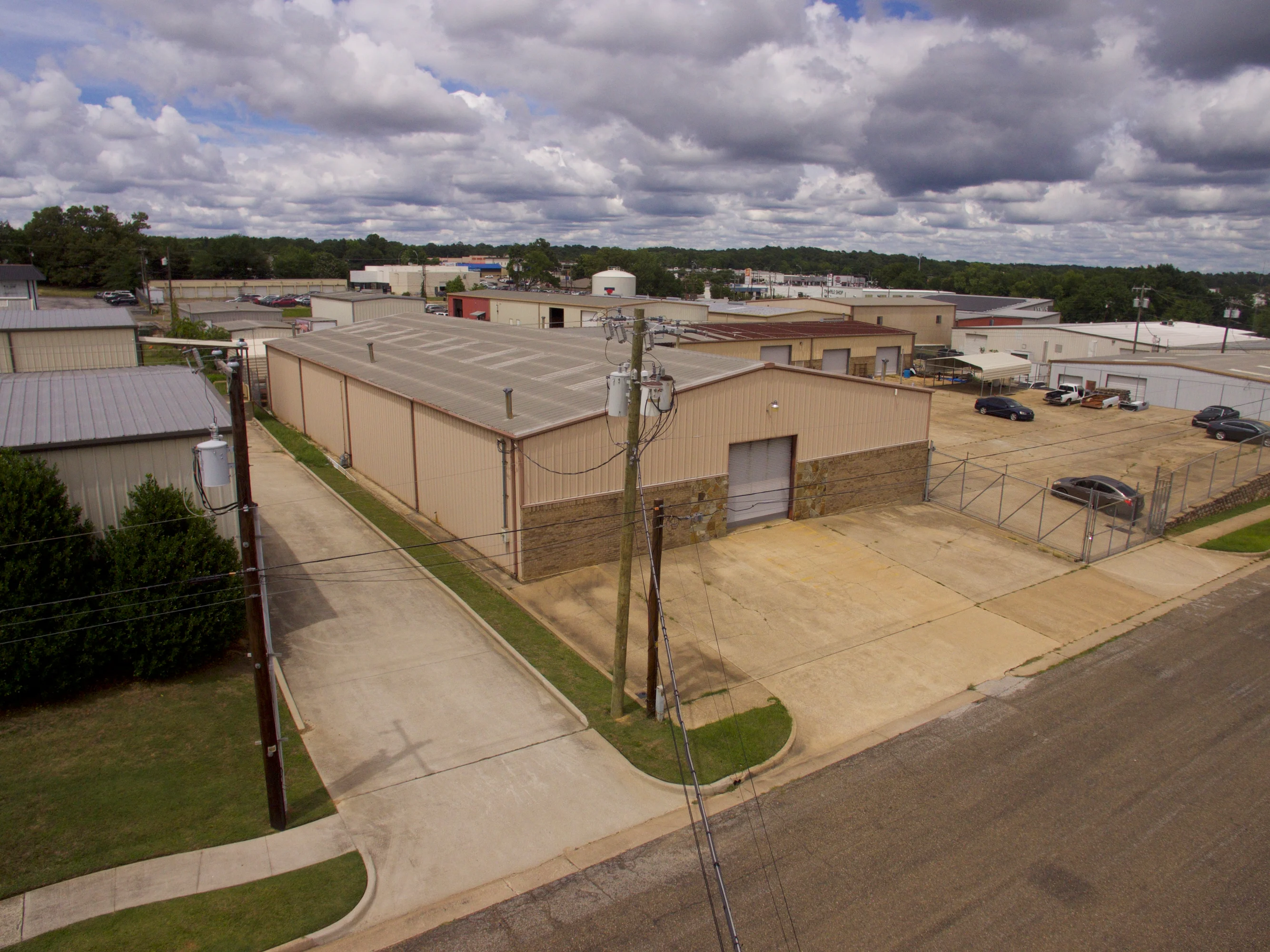Aerial or elevated view of the two-building Candy Park industrial property and fenced concrete yard at 2005 Broussard Street.