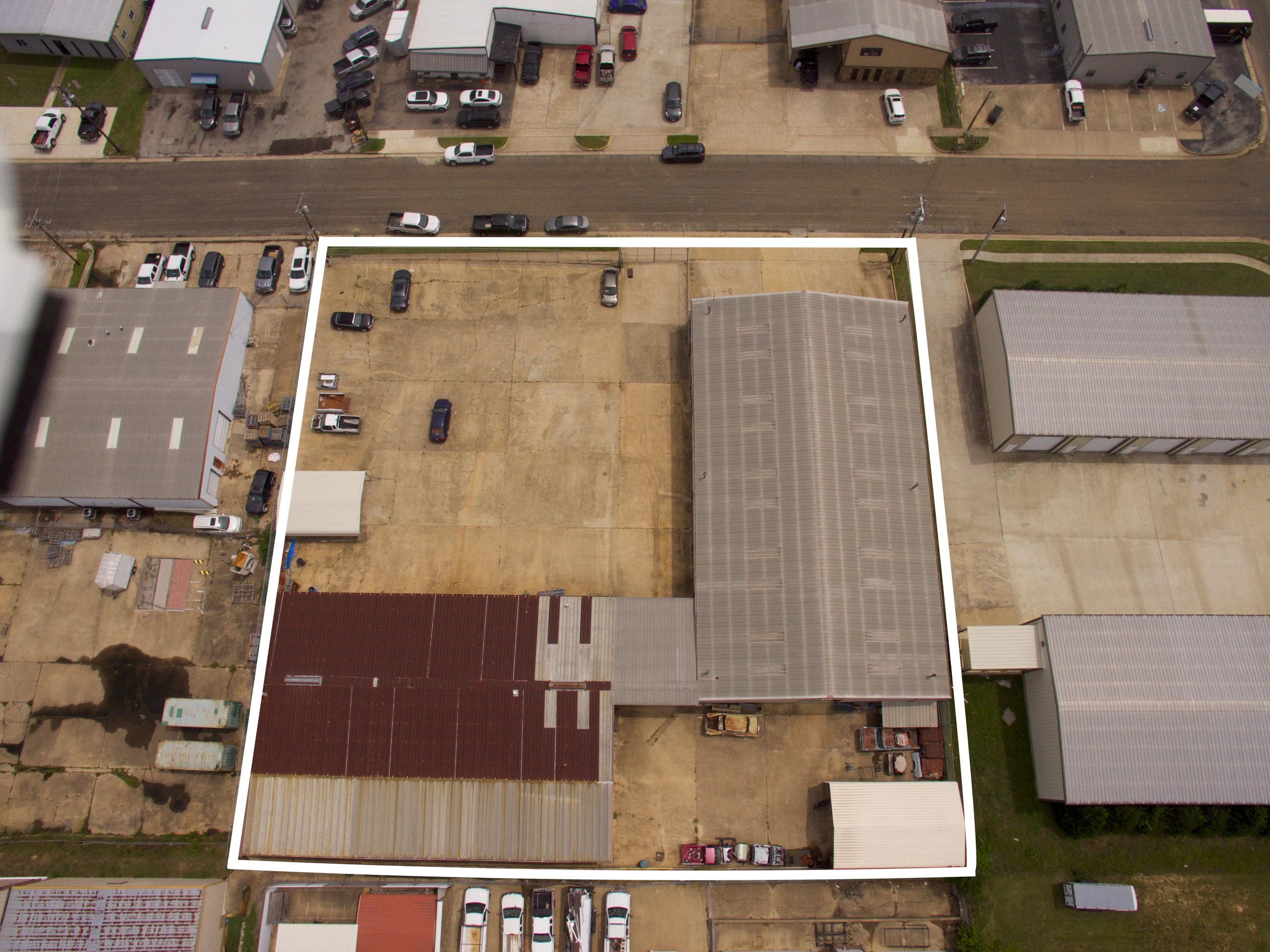 Large concrete yard and parking area for fleet vehicles, equipment staging, and loading at Candy Park.