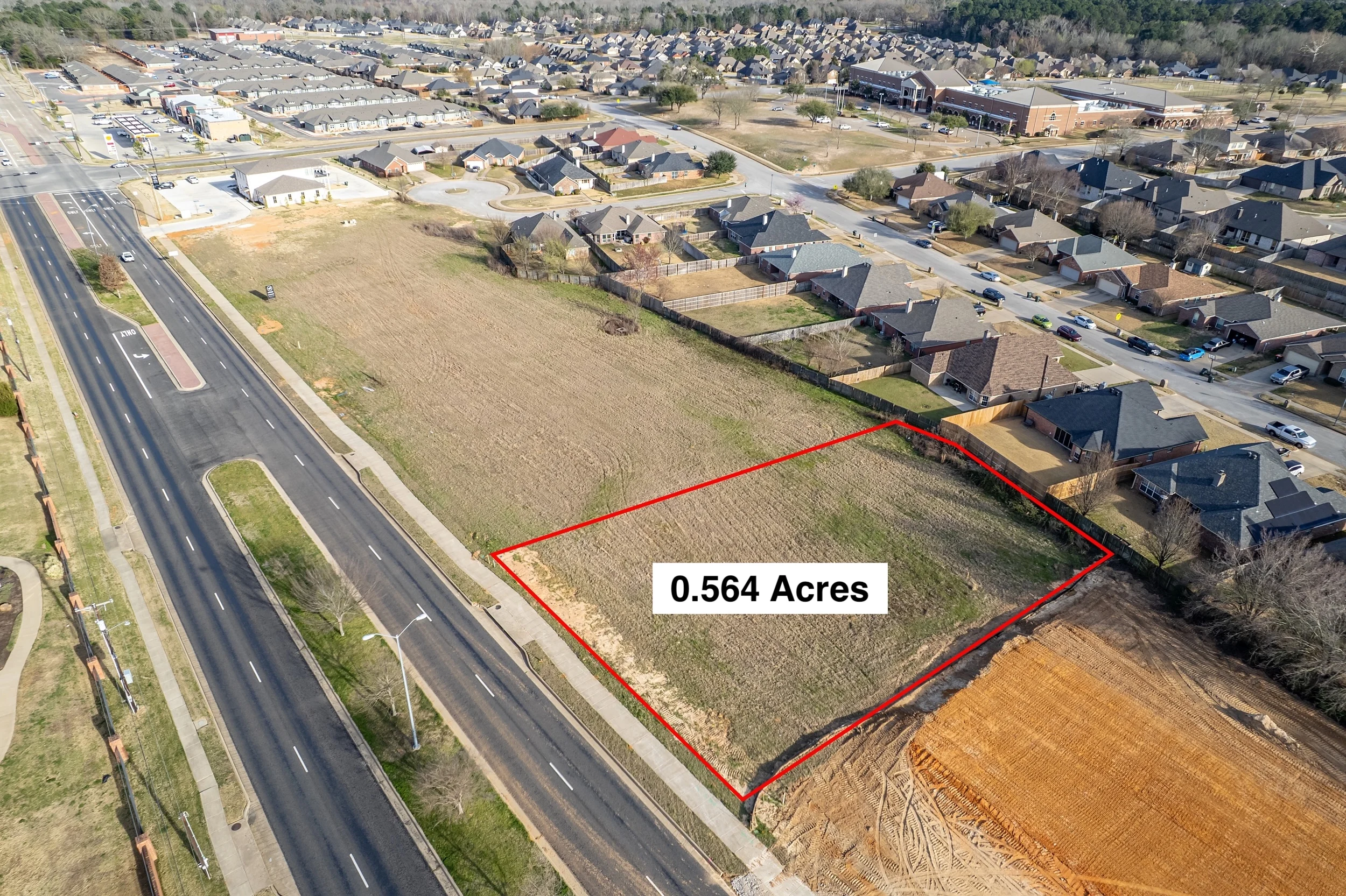 Aerial view emphasizing Blue Mountain Boulevard frontage and access to the available commercial parcels.