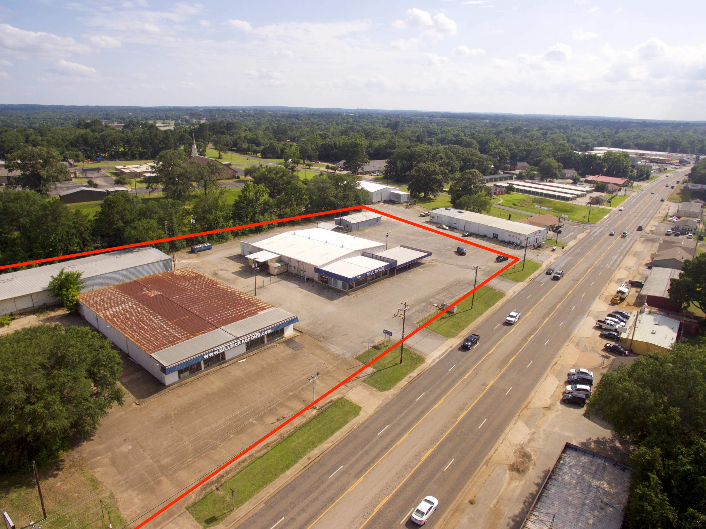 Front exterior of the former dealership showroom at 1511–1515 E. Rusk Street in Jacksonville.