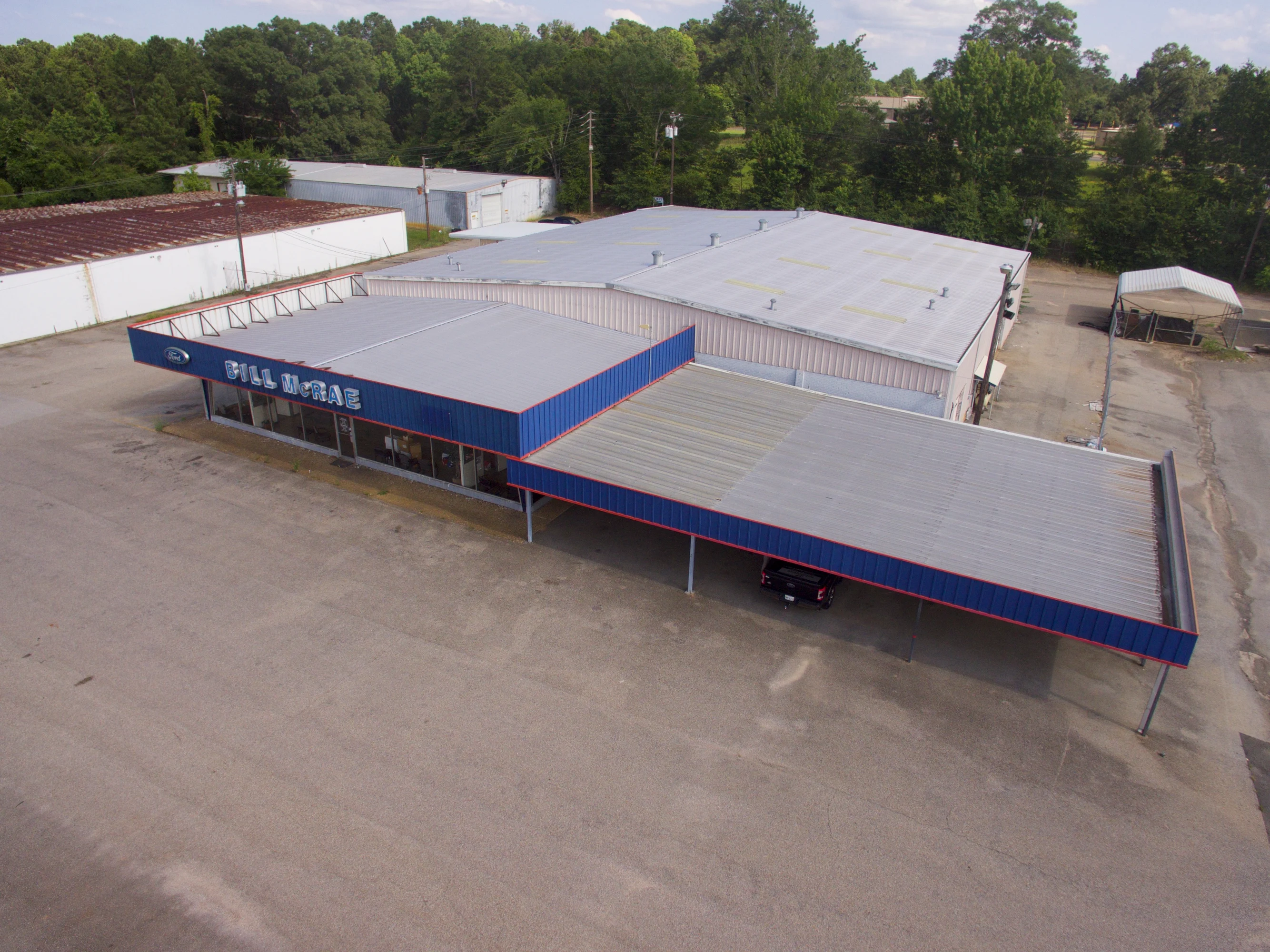 Interior of the former automotive showroom with open customer-facing floor space.