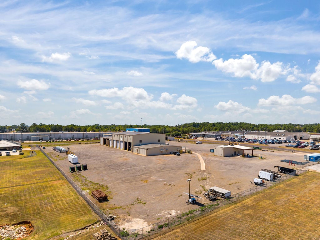 Aerial view of the main facility's metal shop, standalone office and expansive gravel truck yard.