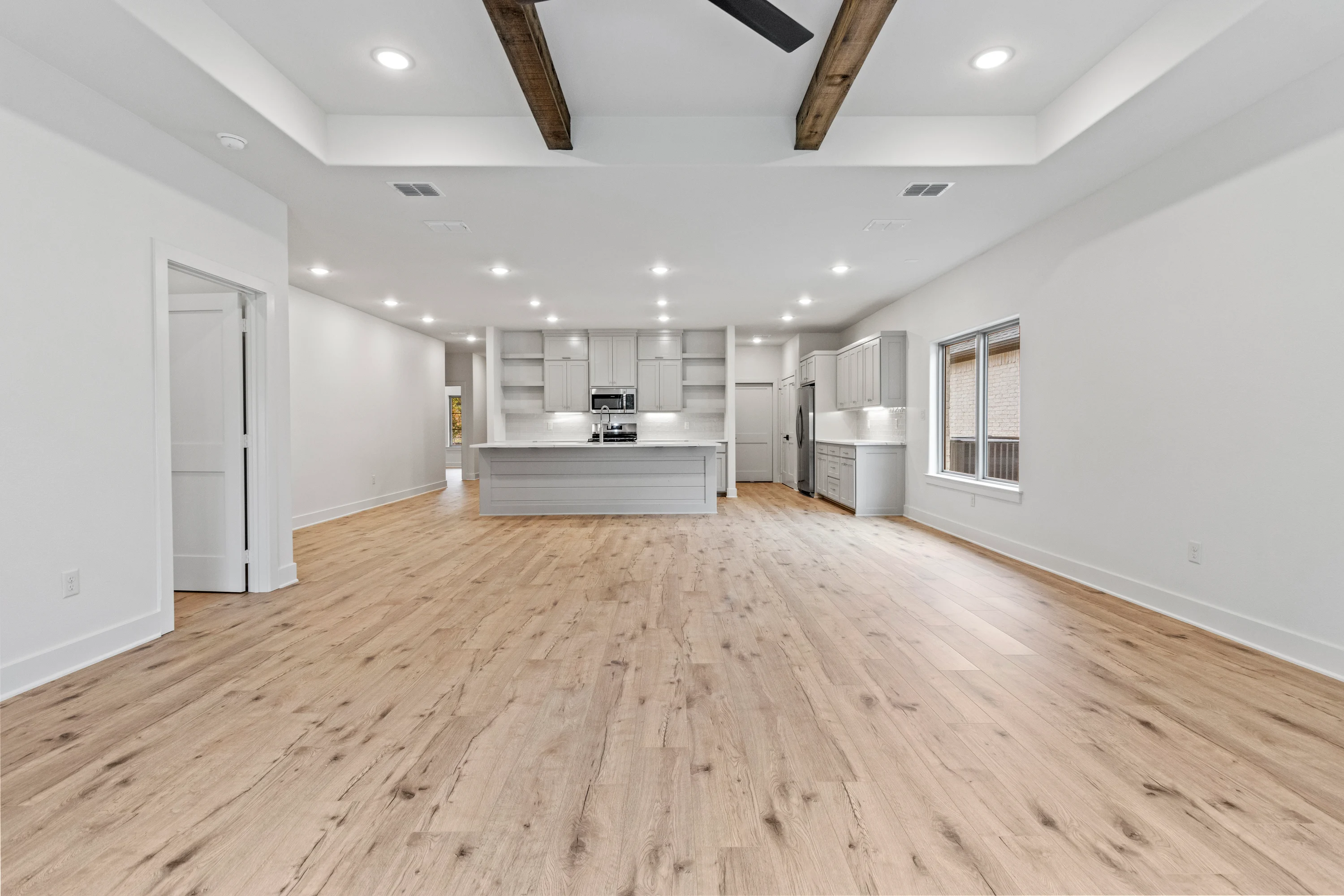 Bright living room with high ceilings and contemporary finishes in a Henshaw Creek residence.