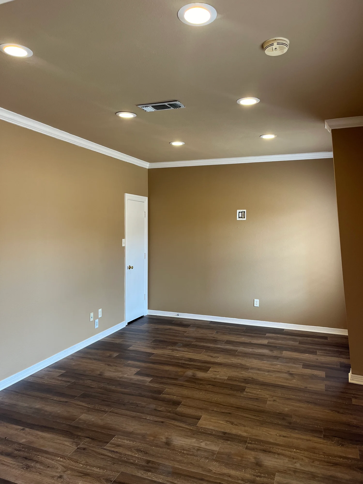 Empty office or conference room with recessed lighting and vinyl plank floor at Highway 110 Industrial in Tyler, Texas.