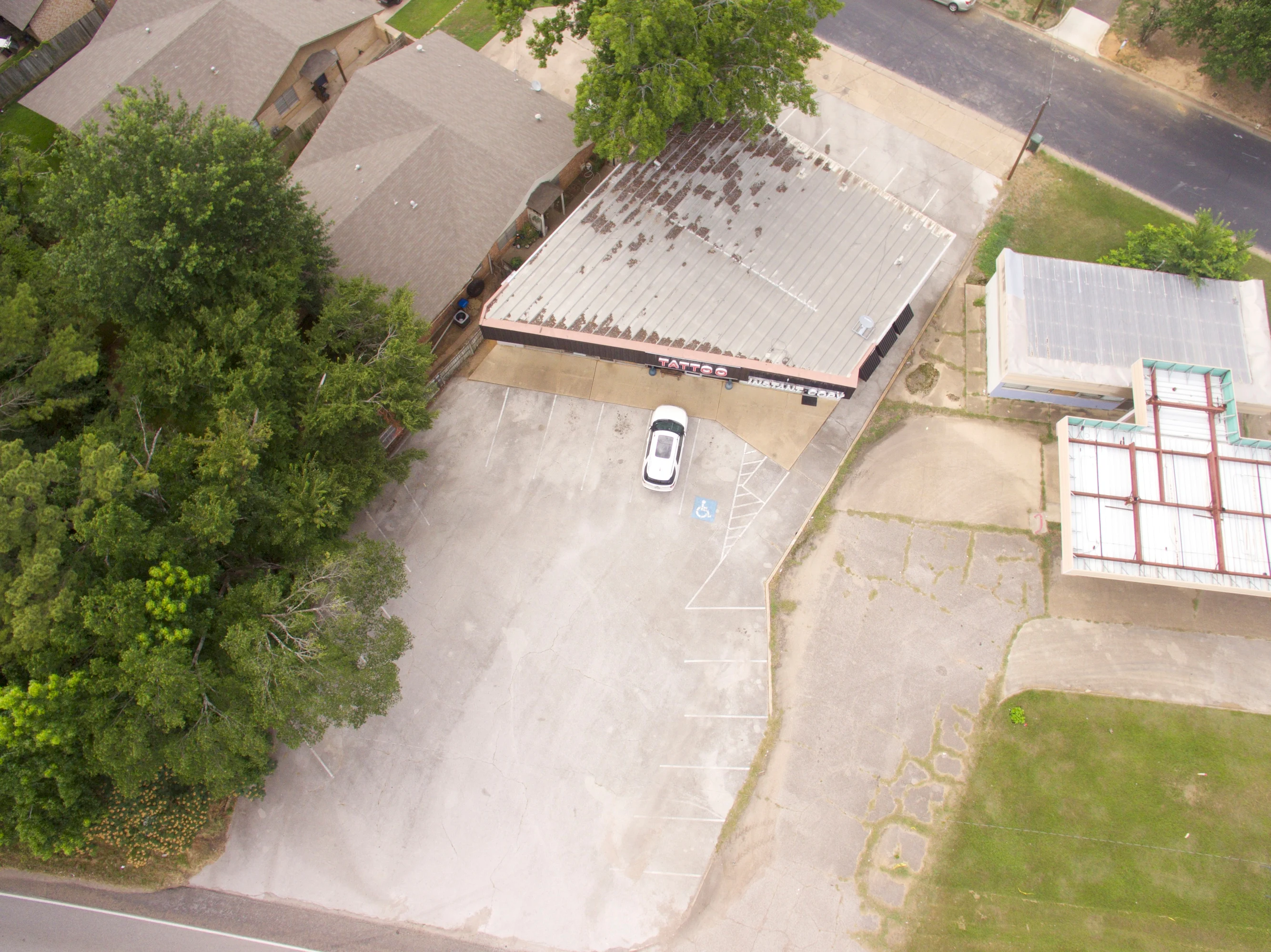 Site view showing the retail building, parking area, and surrounding Loop 323 commercial corridor.