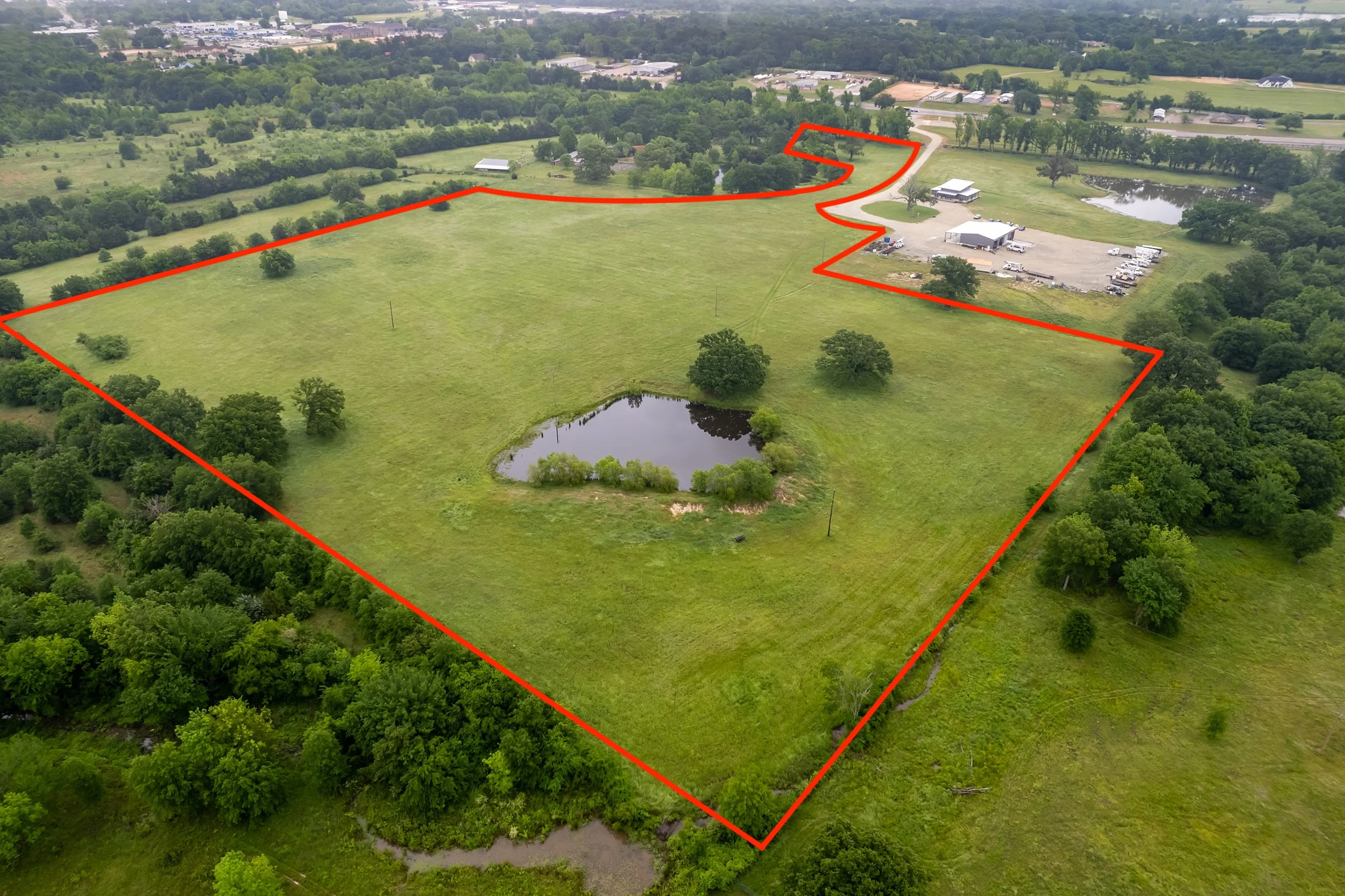 Closer aerial view showing highway frontage and access along the US-69 development property.